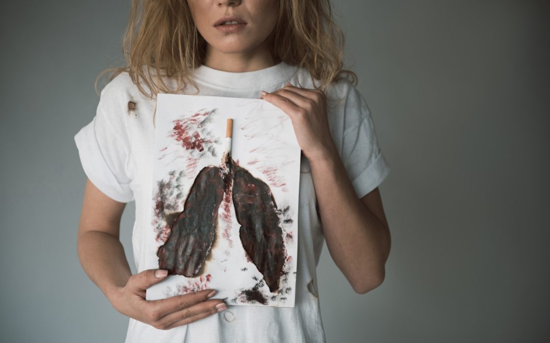 girl holding picture showing dangers of nicotine